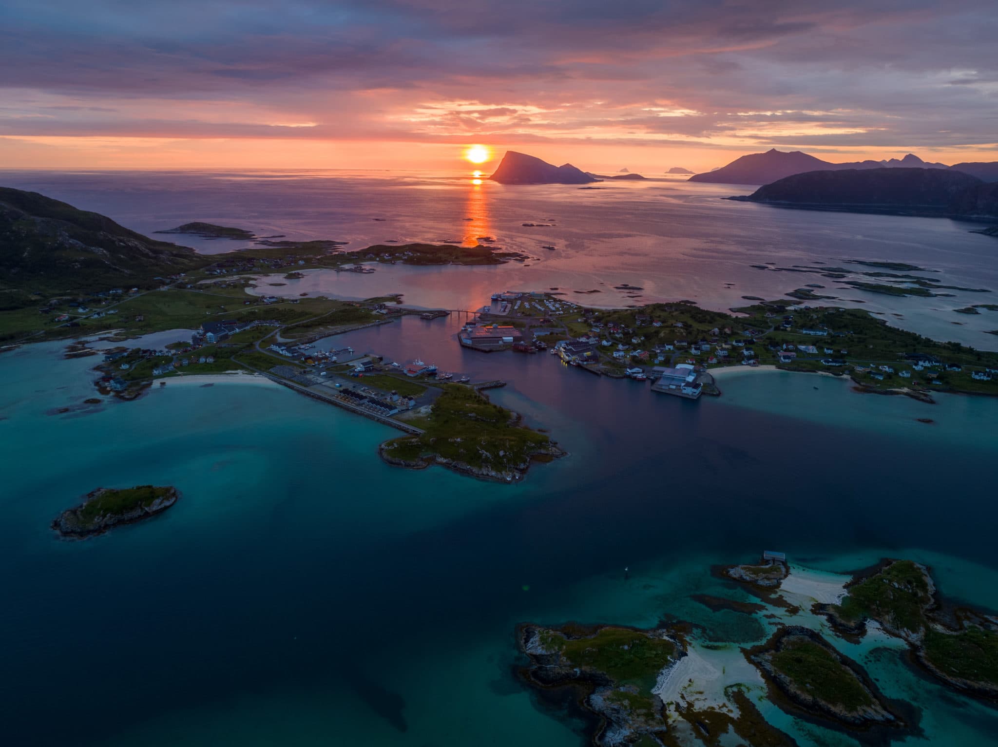 Midnight sun over Sommarøy islands and turquoise Arctic waters near Tromsø, Northern Norway