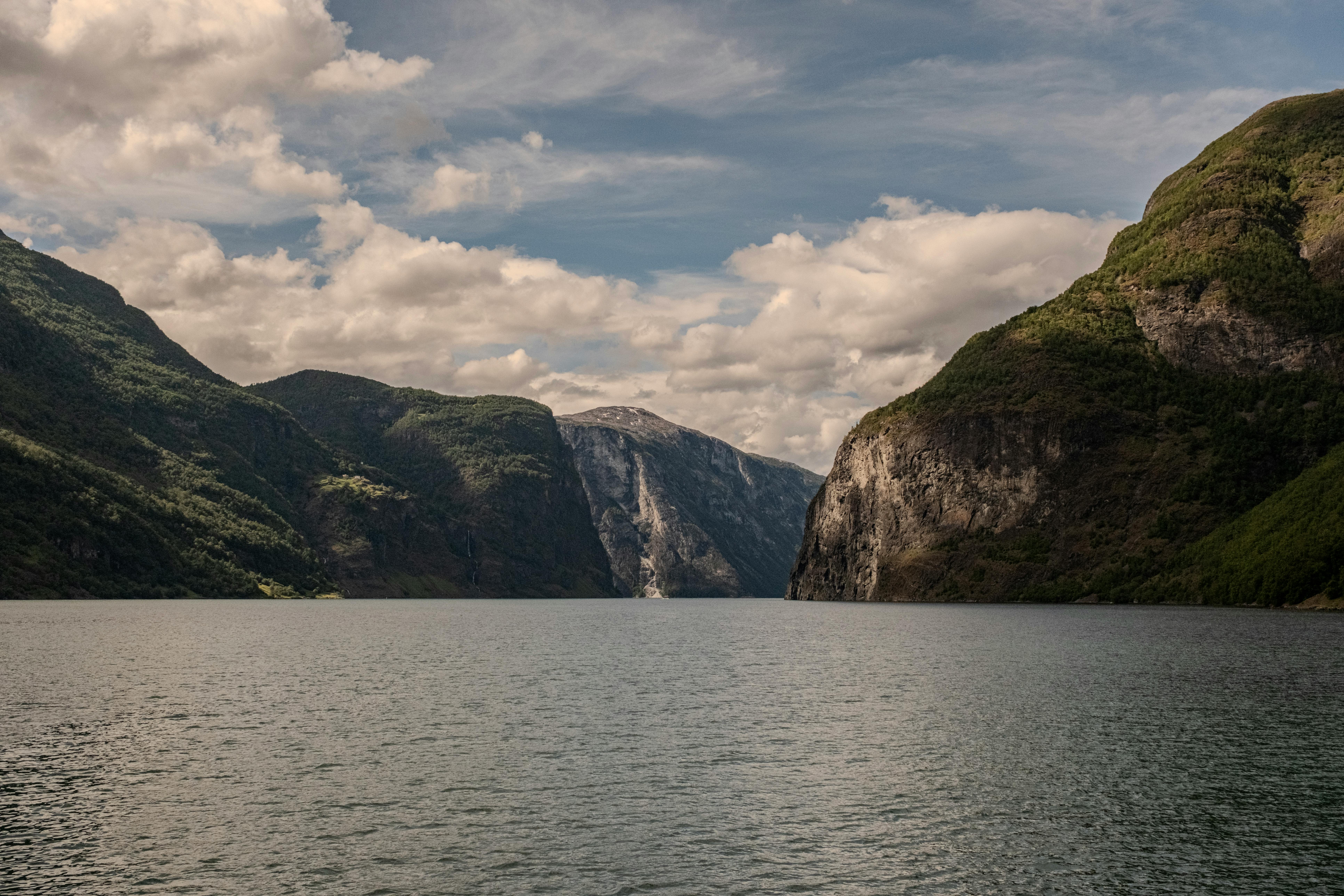 Kayak perspective on Nærøyfjord. 1,400-meter walls rising directly from the waterline.