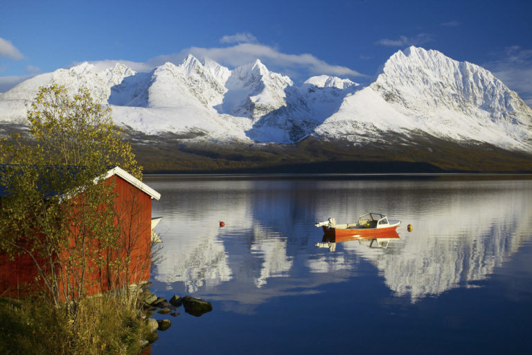 Snow-covered Lyngen Alps peaks in October with low cloud and limited visibility