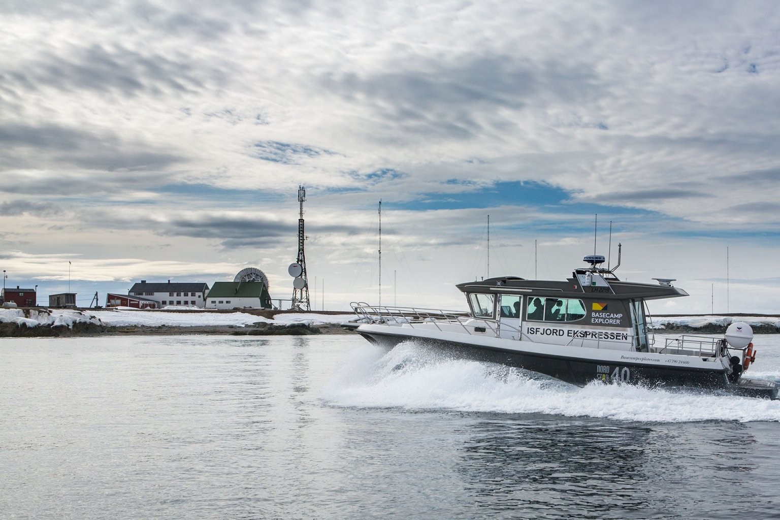 Hiker navigating Svalbard terrain with no trail markers, open tundra and mountain backdrop