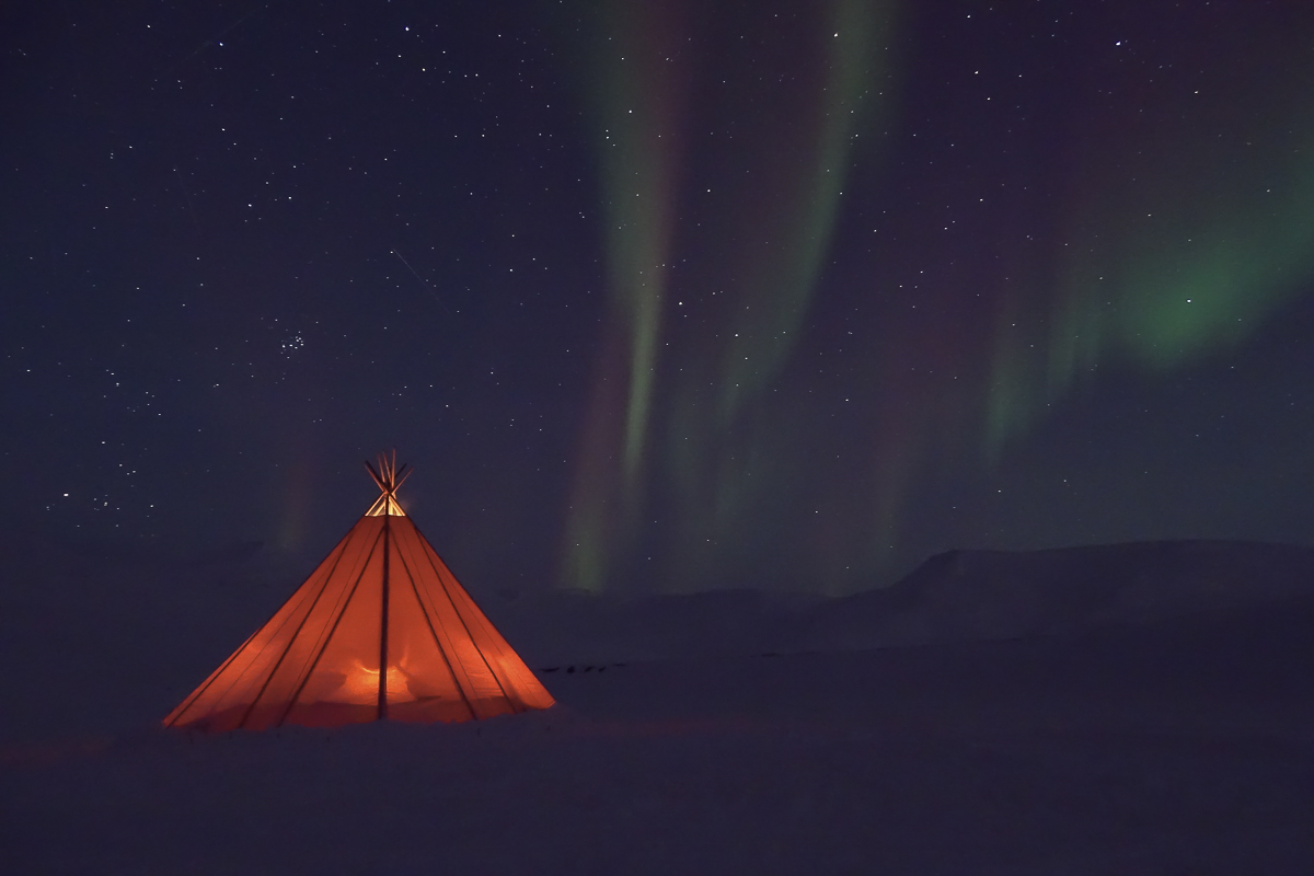 Longyearbyen in polar night, colorful wooden houses under a dark blue twilight sky