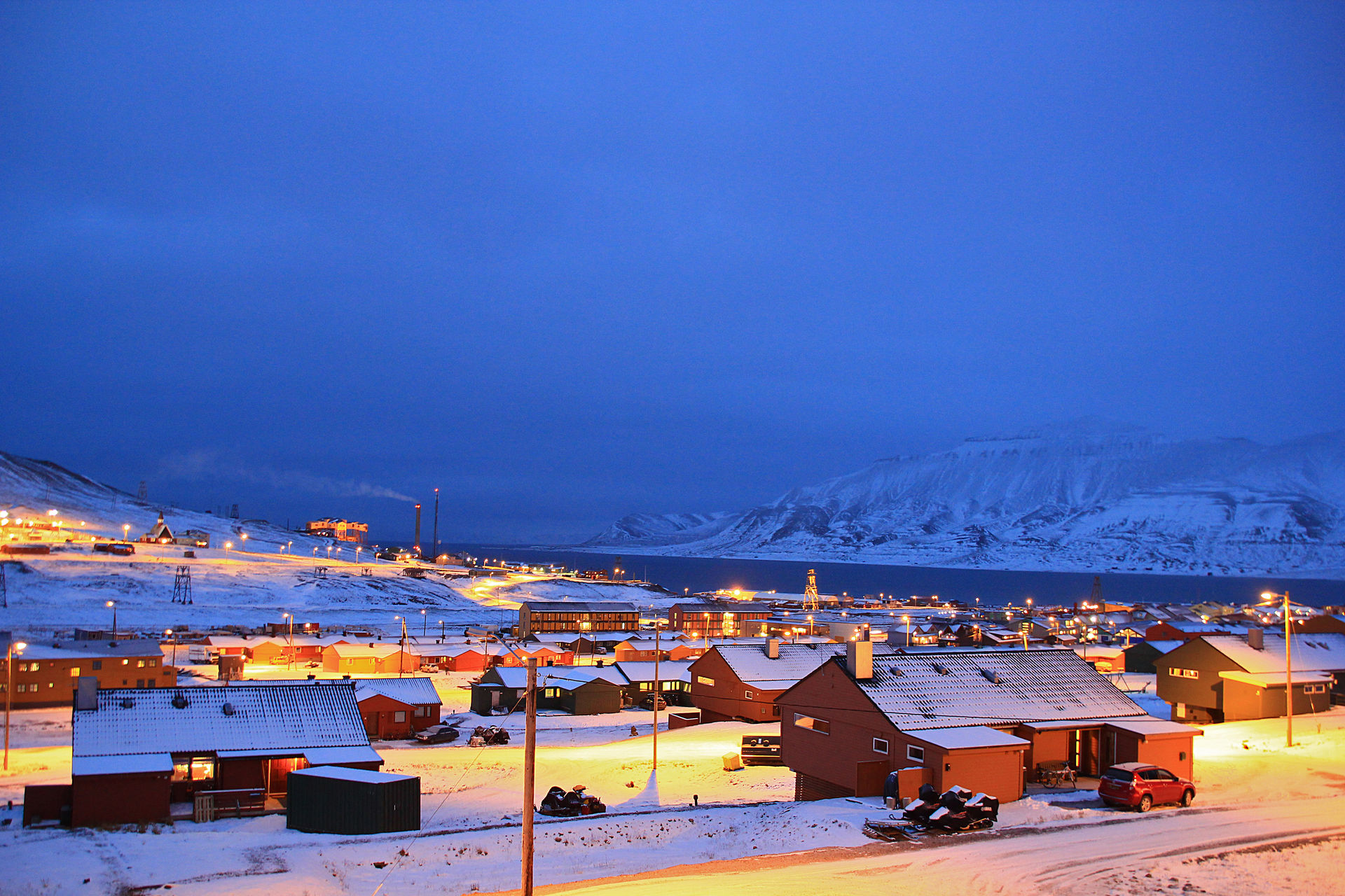 Platåberget plateau rising directly above the colored houses and harbor of Longyearbyen, Svalbard